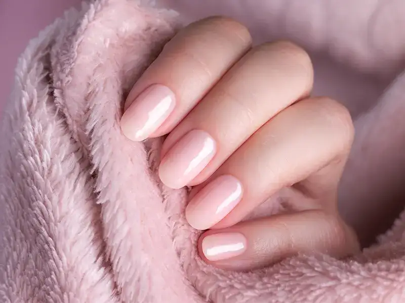 Before and after photo of manicured hands with soft pastel nail polish