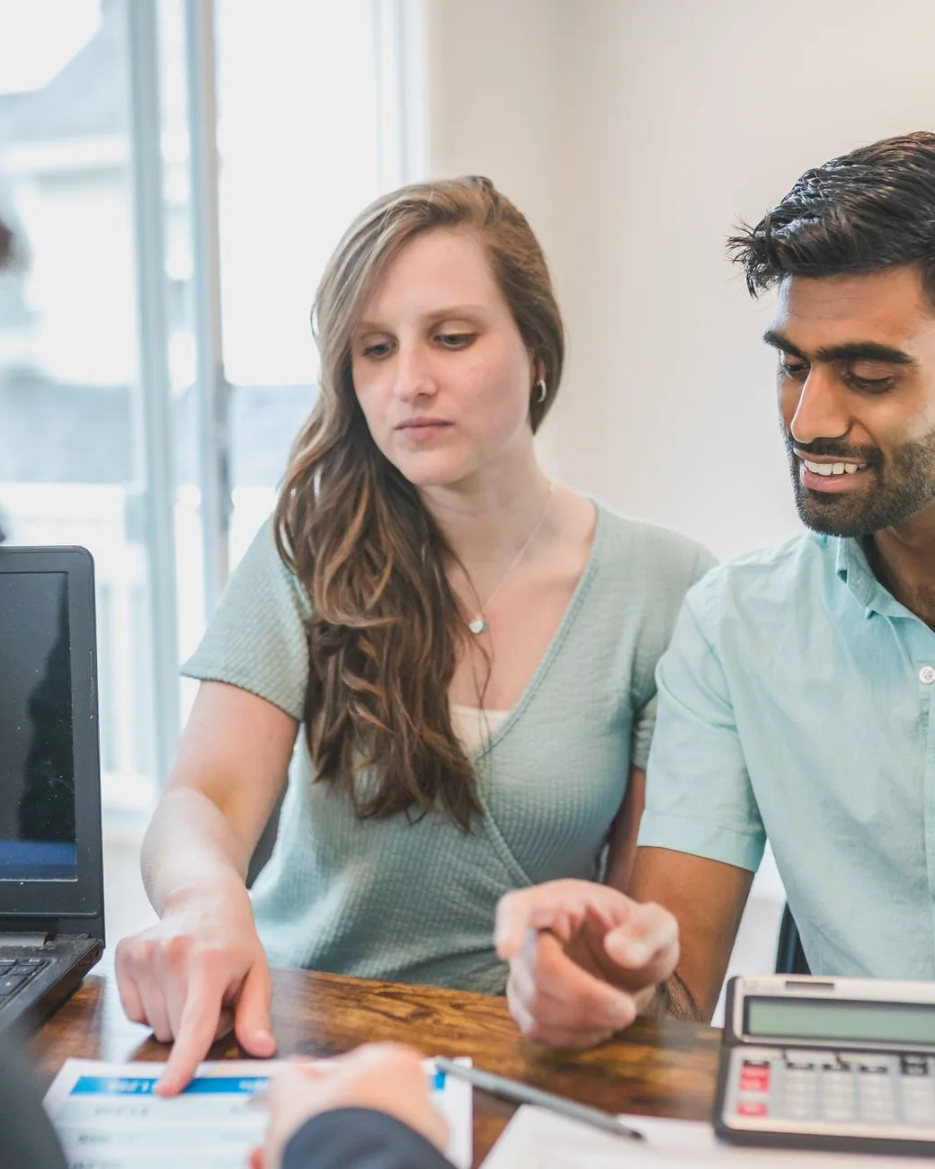 A young couple going over their financial plan together with their Clearpath planner