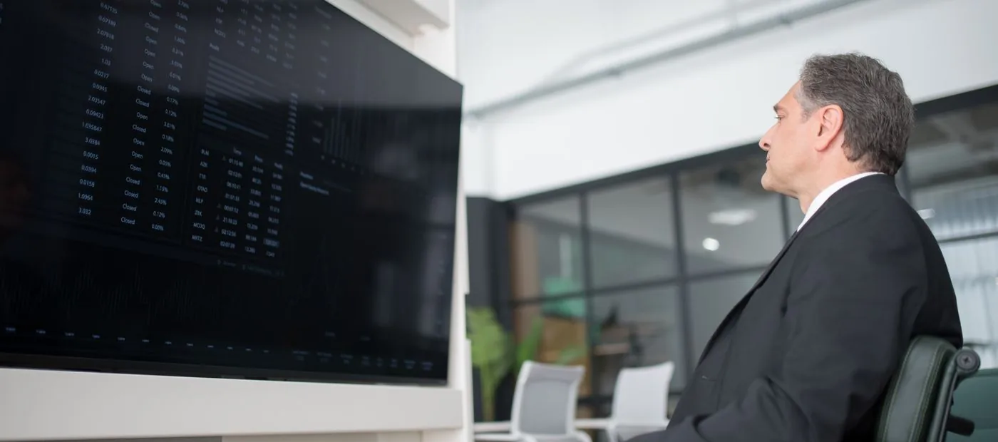 Everpeak Wealth — a senior advisor reviewing market positions in a private office