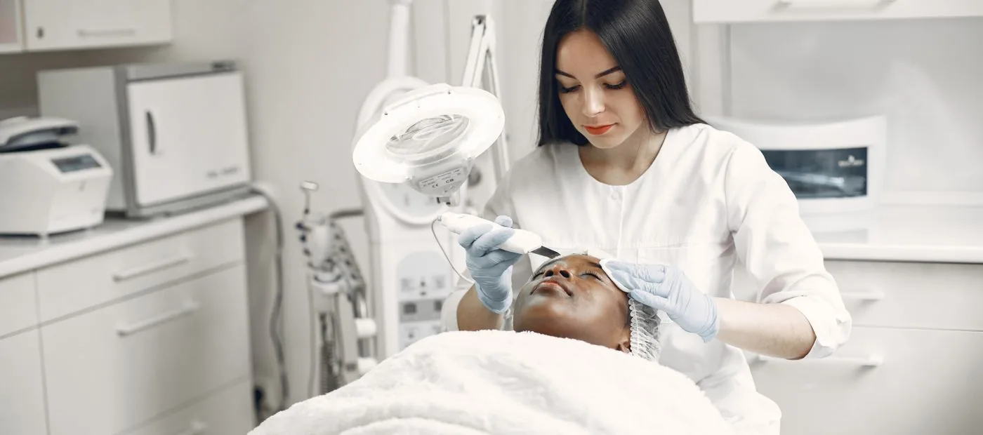 A facialist at work in the treatment room at The Glow Room