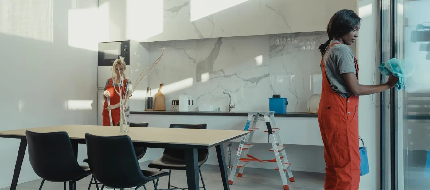 BrightNest cleaners brightening a sunlit modern kitchen