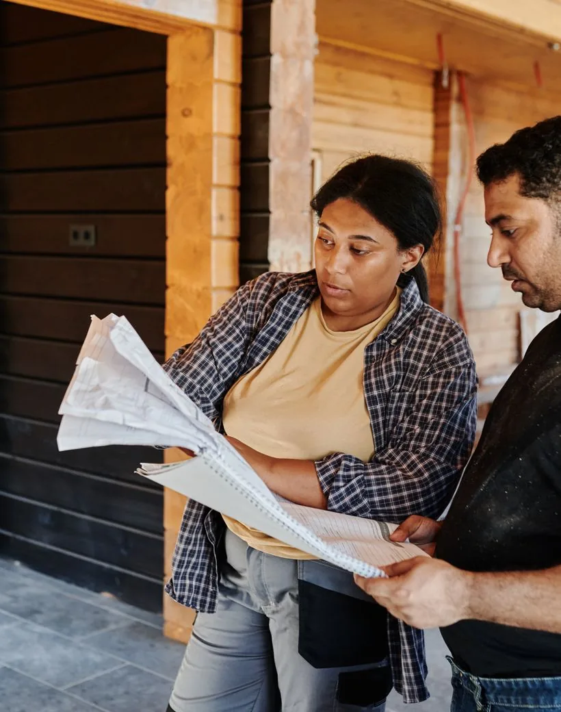 Hearthstone Remodeling — builders reviewing the project plan together on site
