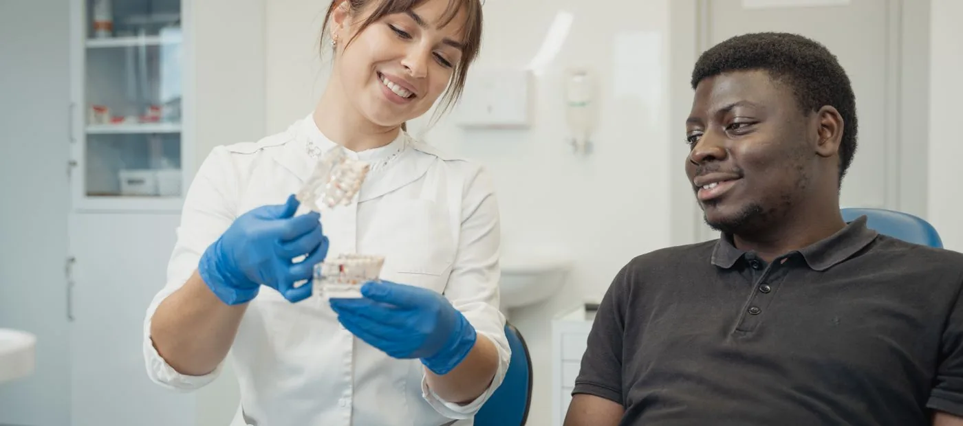 A Brightwater hygienist showing a happy patient their treatment plan