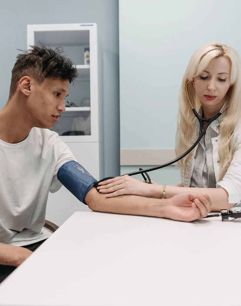 A Northvale clinician checking an adult patient's blood pressure