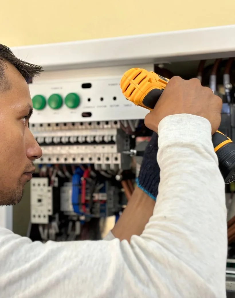 VoltLine electrician working on a home electrical panel