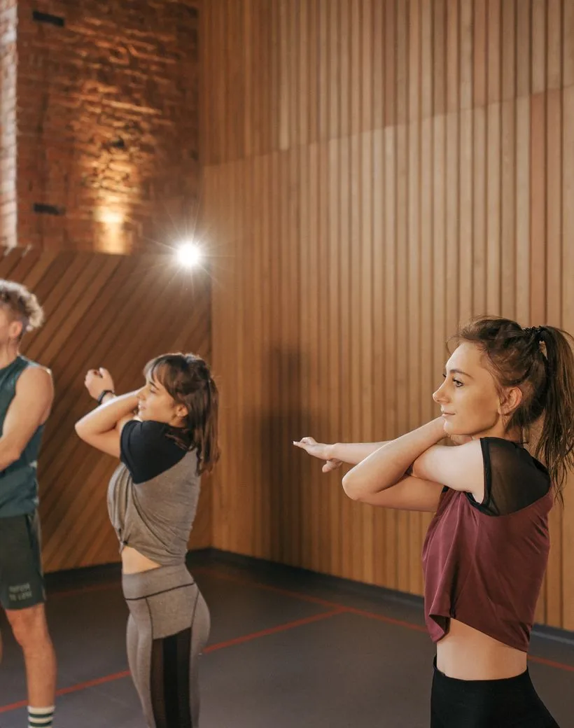 Members moving through a coached warm-up together at the start of a class