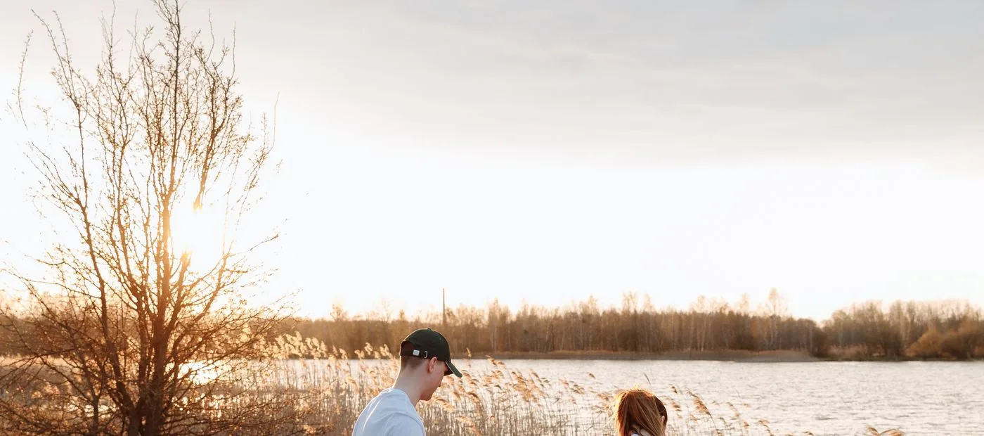 Rivermark Community Foundation — two neighbors by the water at golden hour, a gift meant to outlast a lifetime