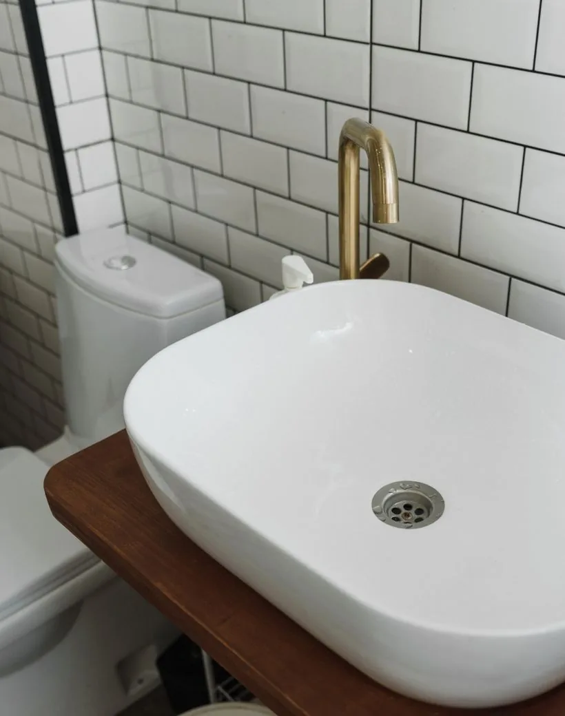 A bright, freshly finished bathroom with a new faucet and fixture