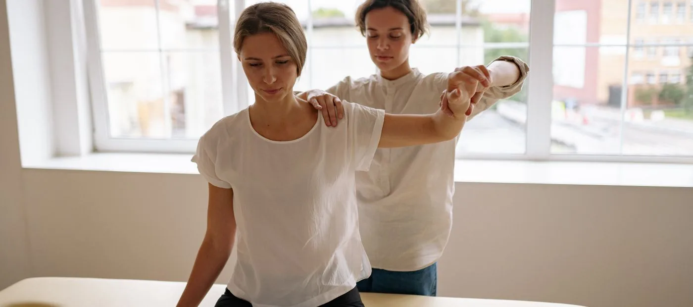 Keystone Ortho & Sport — therapist assessing a patient's shoulder range of motion