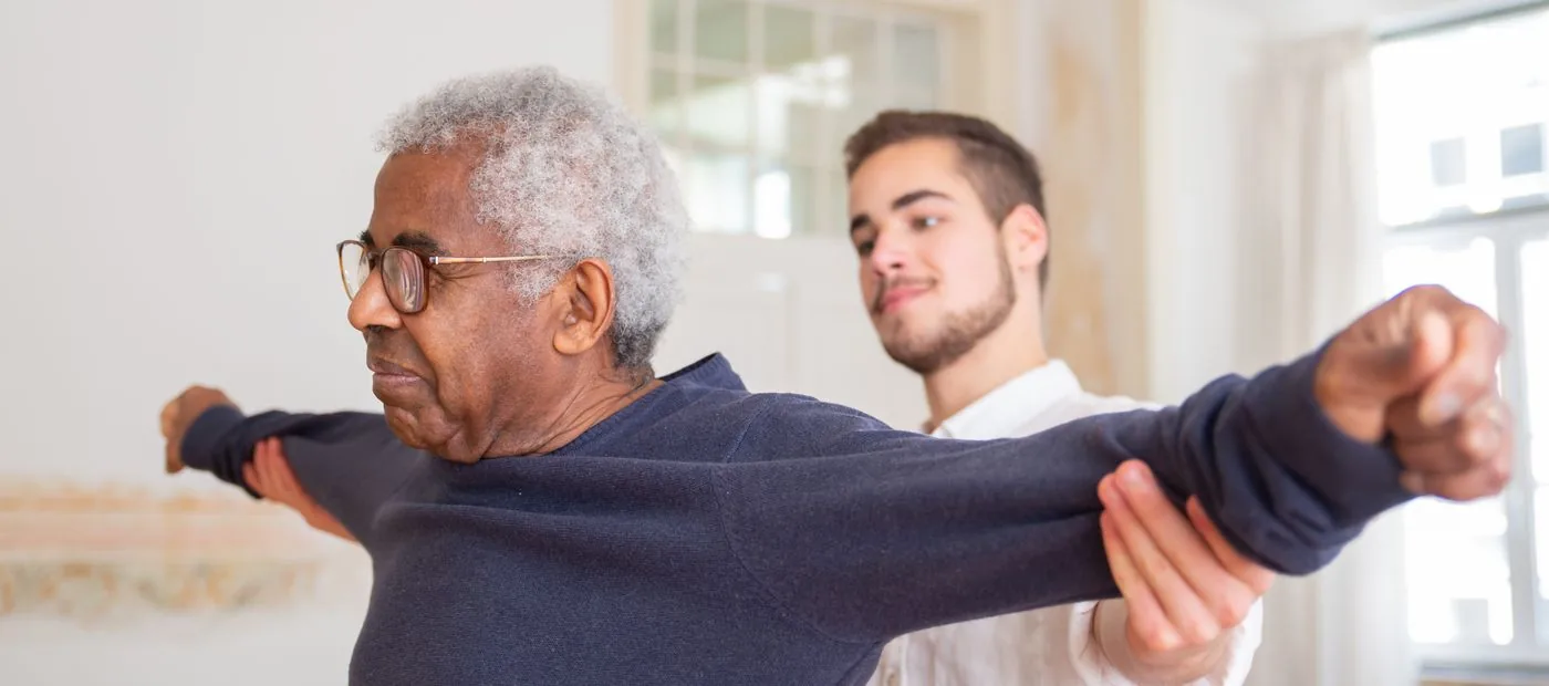 Wellspring Neuro & Balance — therapist gently guiding an older adult through a seated exercise