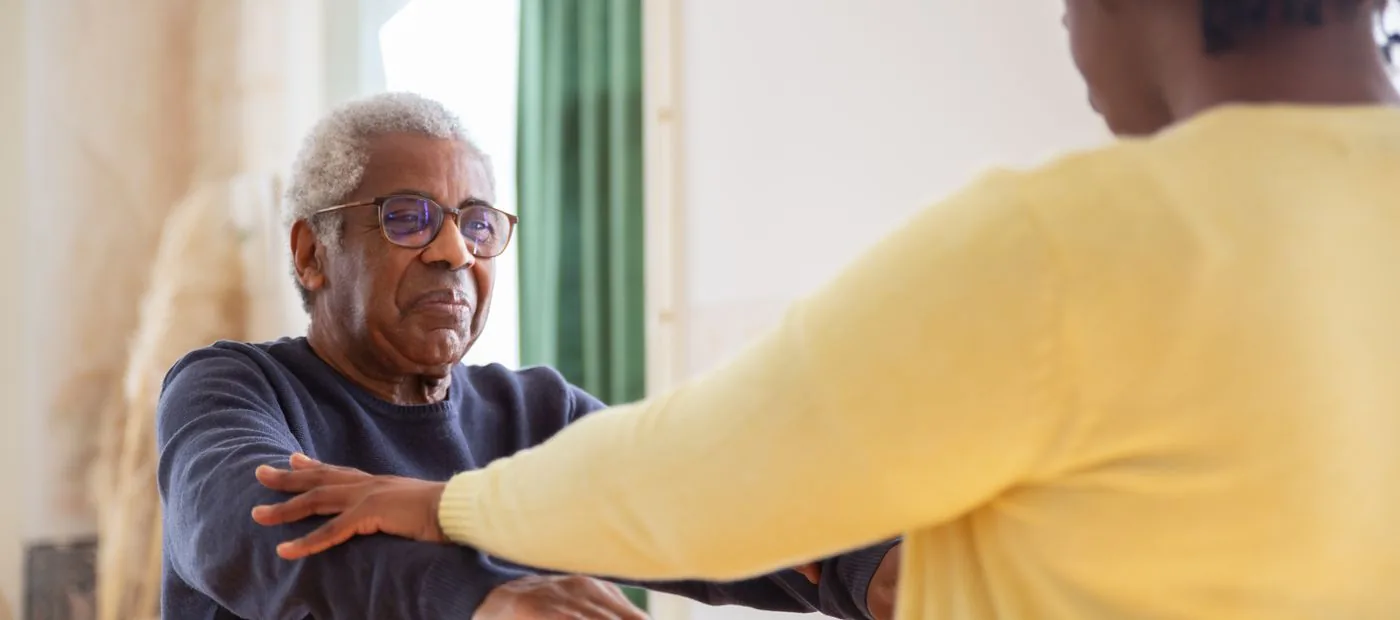 Wellspring Neuro & Balance — patient, hands-on care helping an older adult through a gentle stretch