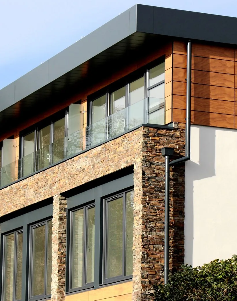 A modern commercial building with a flat low-slope roof serviced by Apex