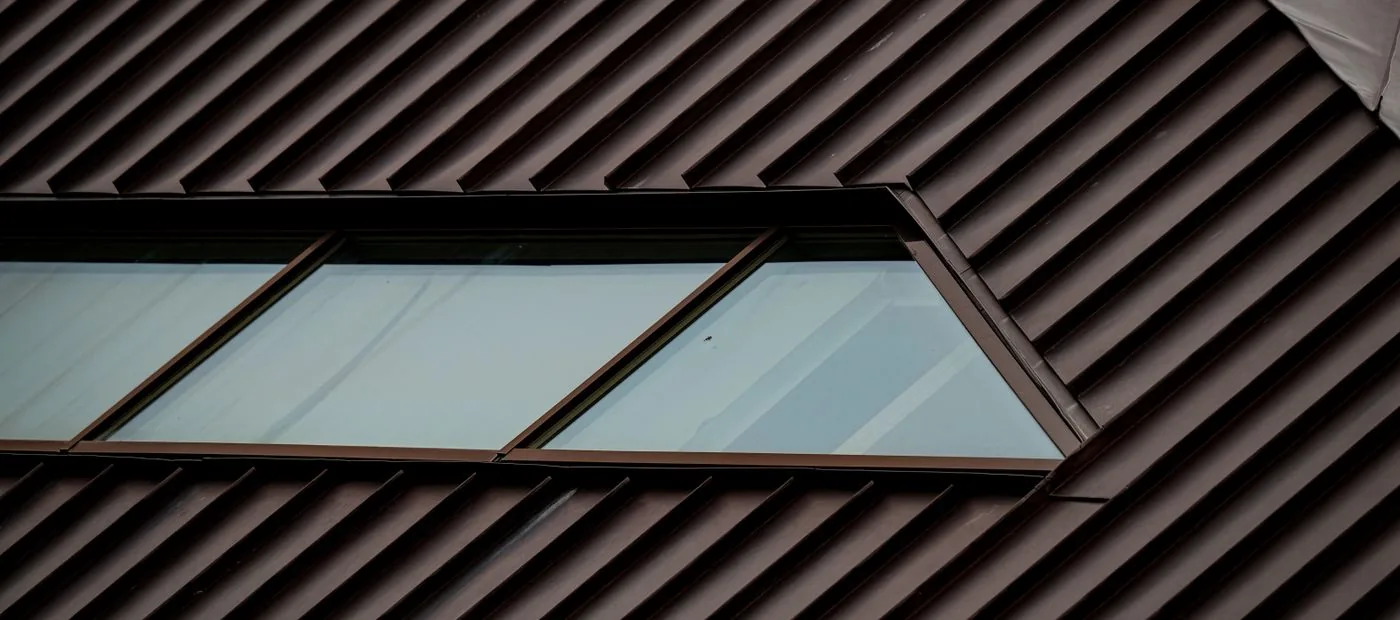Ironcrest Metal & Slate — architectural standing-seam metal roof with inset skylight