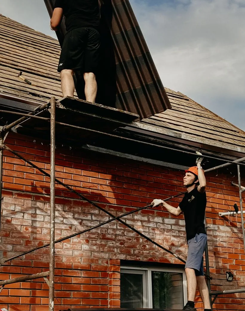 Ironcrest craftsmen installing a metal roof on a fine home