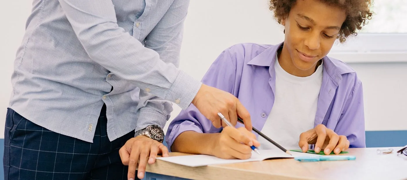 ClearChapter — a tutor working through a math problem one-on-one with a focused student