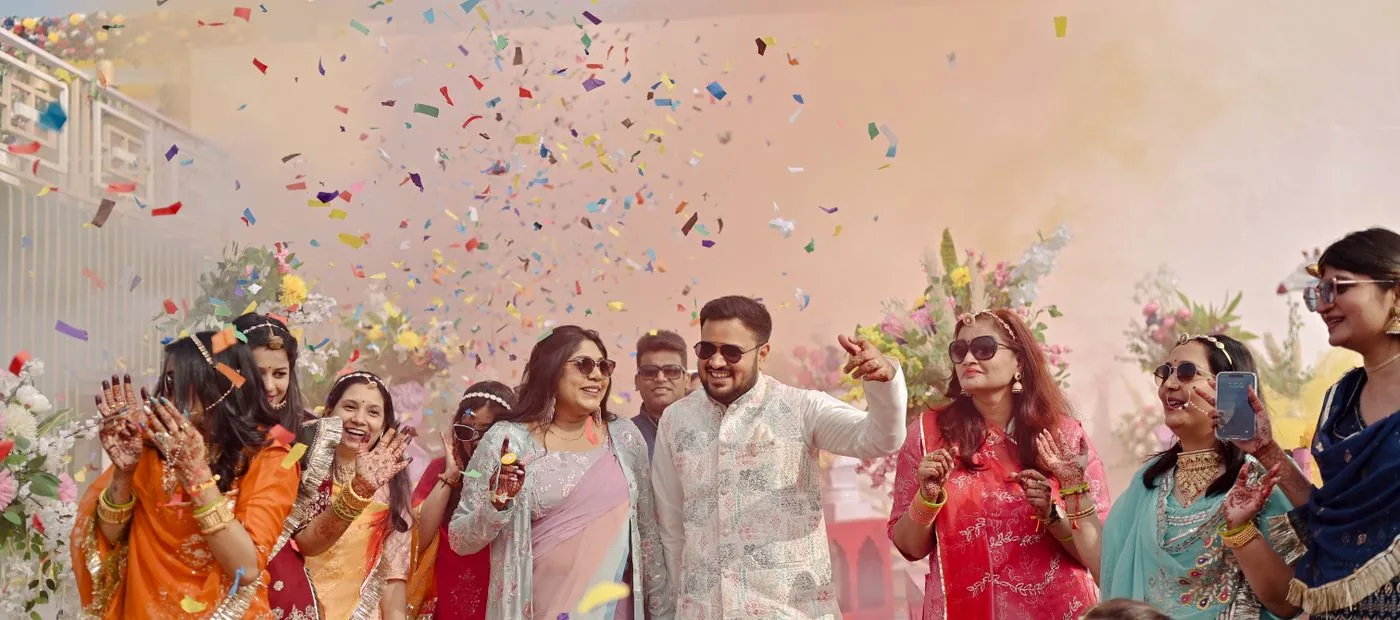 Confetti & Co. — a couple celebrating in a shower of colorful confetti