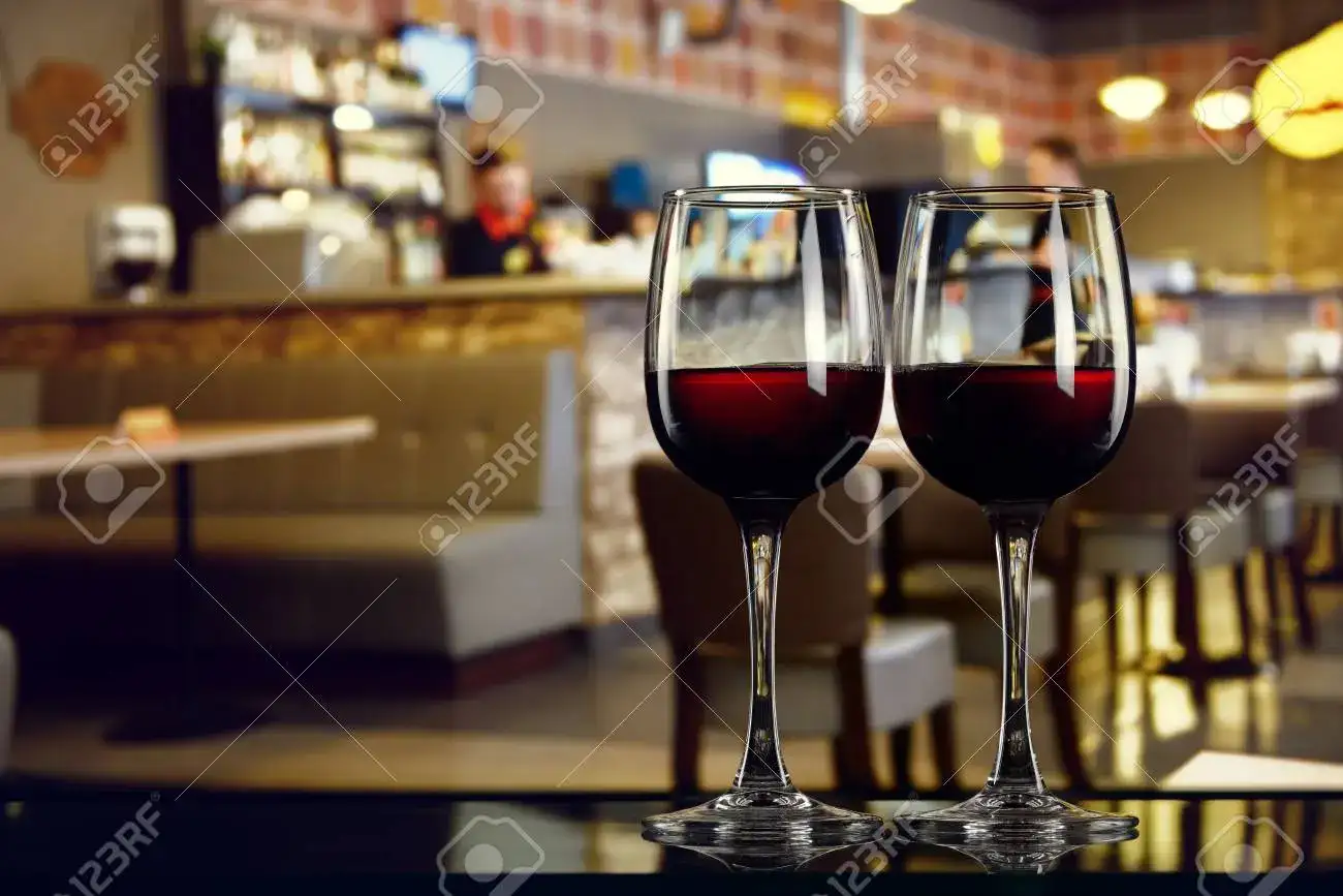 Wine glasses and bottles on a bar counter