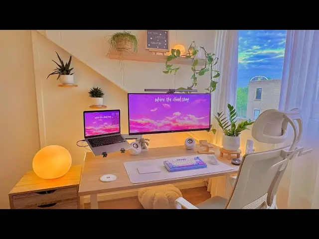 Creator working on laptop in a cozy studio with warm lights