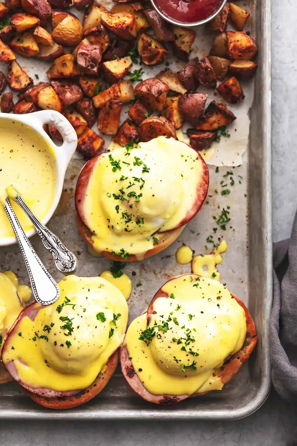 Eggs Benedict with potatoes and hollandaise sauce